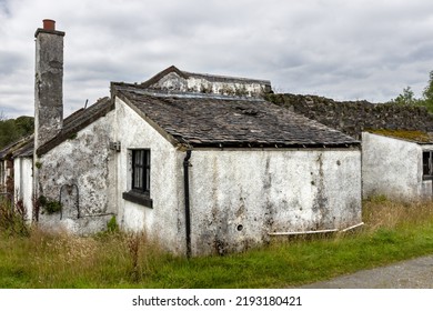 Croft House. Derelict Farm Building In Scotland UK. Crofter Cottage And Barn In Need Of Repair As A Renovation Project. Rural Home By Traditional Stone Wall.