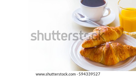 croissant with coffee and orange juice on a white background