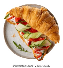 Croissant sandwich with cream cheese, smoked salmon, cucumber and arugula on gray plate isolated on white. Top view. - Powered by Shutterstock