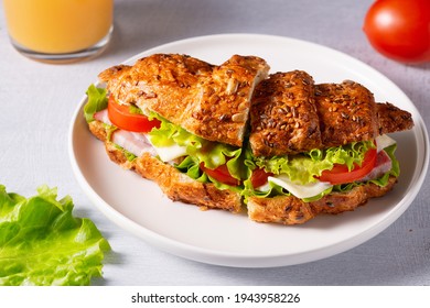 Croissant Sandwich With Meat, Vegetables And Cheese White Background. Breakfast Food Concept.