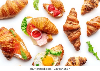 Croissant sandwich variety. Various stuffed croissants, overhead flat lay shot on a white background. Rolls filled with ham, salmon, egg, etc - Powered by Shutterstock