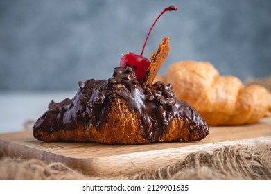 Croissant Topped With Hot Chocolate And Cherry