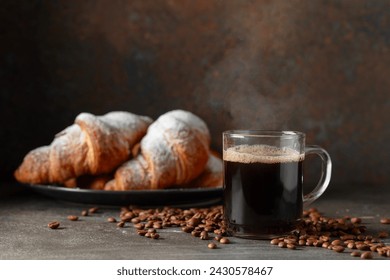 Croissants and black coffee on a kitchen table. Focus on a foreground. - Powered by Shutterstock