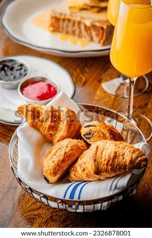 Croissants. Breakfast or brunch buffet. Bagels, blueberry muffins, croissants, cinnamon rolls, scones, sunny side up eggs, bacon, butter, jelly, and cream cheese. Classic American or French breakfast.