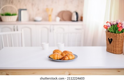 Croissants on the kitchen table. the concept of morning and comfort. - Shutterstock ID 2112224603