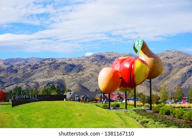 Cromwell/New Zealand: Apple Pear Cherry Apricot Stone Fruit Symbol In Center Of Cromwell Cherry Capital Famous Tourist Destination Blue Sky Green Grass Meadow On Sunny Day 