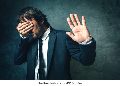 Crooked Politician Hiding Face From Newspaper Photographers After Political Scandal,  Public Embarrassment, Hand Gesturing Stop Sign