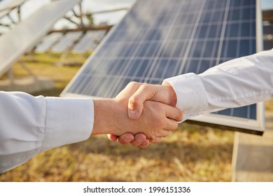 Crop Anonymous Male Business Partners Shaking Hands As Symbol Of Agreement While Standing Near Photovoltaic Panels On Agricultural Solar Power Station