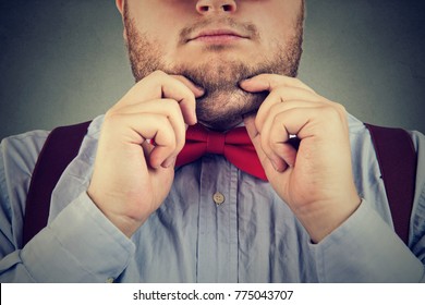 Crop chubby man in bow tie showing second chin suffering from obesity.