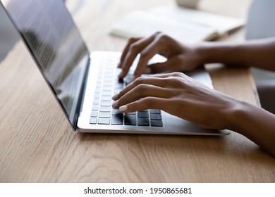 Crop close up of African American woman sit at desk at home office type text on modern laptop gadget. Biracial female use computer consult client work online distant on device. Technology concept. - Powered by Shutterstock