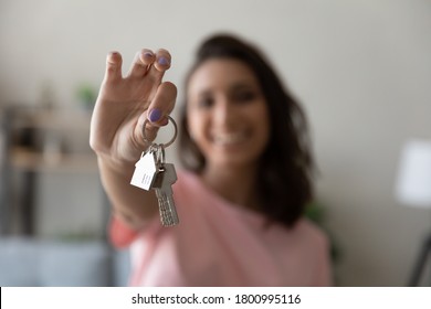 Crop close up of female tenant renter show praise house keys moving to first own new apartment or house, happy woman owner buy purchase home, relocate to dwelling, rental, rent, ownership concept - Shutterstock ID 1800995116