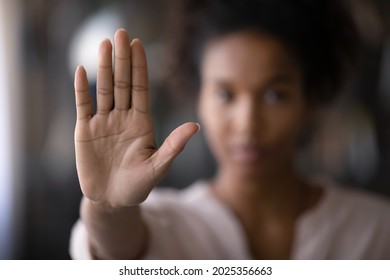 Crop close up focus of African American woman show palm hand against racial gender discrimination. Determined mixed race female make sign gesture protest against domestic violence or abortion. - Shutterstock ID 2025356663