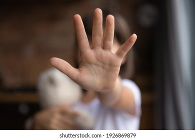 Crop close up of little girl child stretch hand show no gesture protest against domestic violence. Small teen child stand against discrimination or school abuse. Childhood problem, voice concept. - Shutterstock ID 1926869879