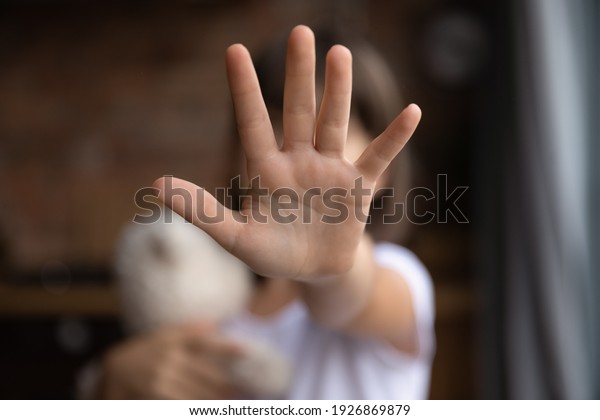 Crop close up of little girl child stretch hand\
show no gesture protest against domestic violence. Small teen child\
stand against discrimination or school abuse. Childhood problem,\
voice concept.