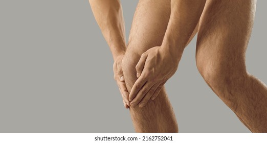 Crop close up of naked man hold knee suffer from acute spasm. Pain in kneecap. Male struggle with ache, have muscular strain or nerves inflammation. Trauma or injury concept. Healthcare. - Shutterstock ID 2162752041