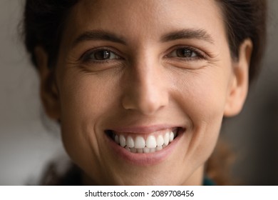 Crop close up portrait of smiling Hispanic woman look at camera feel optimistic positive. Happy Latin female show white healthy even teeth after dental treatment. Dentistry, humor, diversity concept.