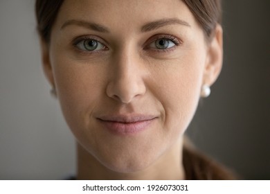 Crop Close Up Portrait Of Young Caucasian Green-eyed Woman Look At Camera Posing. Smiling Millennial Beautiful Female Show Healthy Glowing Soft Face Skin After Facial Treatment. Cosmetology Concept.