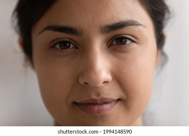Crop close up portrait of young Indian woman with healthy skin, no makeup natural face look. Smiling millennial mixed race ethnicity female renter tenant look at camera. Diversity concept.