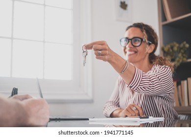 Crop close up of realtor give keys to man buyer or renter buying first home from agency. Real estate agent or broker congratulate male tenant with house or flat purchase. Ownership, rental concept.