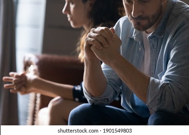 Crop close up of unhappy young couple sit separate have problems in relationship think of breakup or divorce. Upset man and woman family lovers avoid talking suffer from cheating in relation troubles.