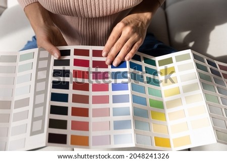 Crop close up of woman look at color palette decorate house or apartment. Caucasian female designer or consultant think of interior design, choose colour for wall decoration. Renovation concept.