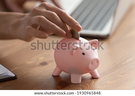 Crop close up of woman put coin into piggybank save money for future, make investment. Female feel provident economical manage family budget or expenses finances. Banking, economy concept.