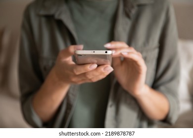 Crop close up of woman text message on modern cellphone gadget at home. Female client customer look at screen browse surf wireless internet connection on smartphone device. Technology concept. - Shutterstock ID 2189878787