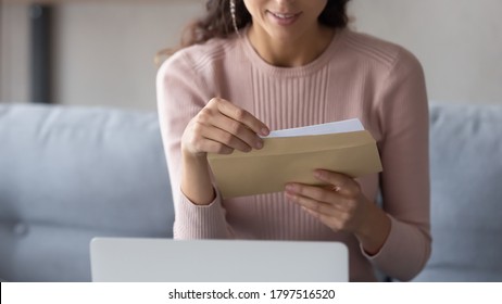 Crop close up of young Caucasian woman hold paper envelope open read postal mail letter at home, female receive post paperwork or document, consider notice or notification correspondence news - Shutterstock ID 1797516520