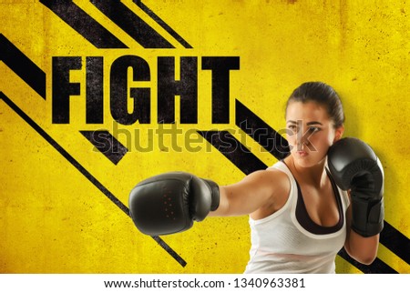 Crop close-up of young woman in boxing gloves holding one hand out, against yellow wall with FIGHT title and black diagonal lines. Set goals. Keep your body strong. Achieve success.