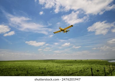 Crop duster airplane in action over the Flint Hills of Kansas - Powered by Shutterstock