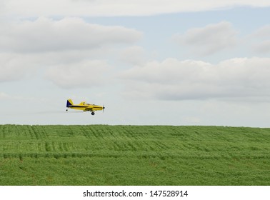 A Crop Duster Spraying A Filed