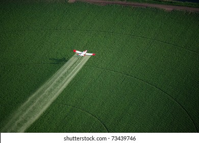 A Crop Duster Working In A Farm Field