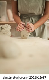 Crop Female Potter Kneading Clay