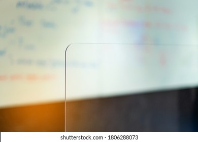 Crop Image Of Acrylic Plexiglass Separator Standing Partition Wall On The Desk In The Meeting Room. Social Distancing In Offices During The Covid-19 Pandemic. Precaution And Safe.