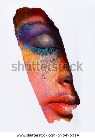 Crop image of female face with eyes closed with colorful powder make up on white background. Beautiful fashion model with creative art makeup. Abstract colourful splash make-up. Holi festival