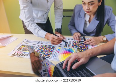 Crop image of worker checking print quality of media graphics proof print in printing industry. Selected focus