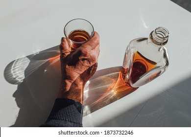 Crop Man With Glass Of Wisky To View Anonymous Male With Glass Of Whiskey From Bottle While Sitting At Table And Drinking Alcohol At Home