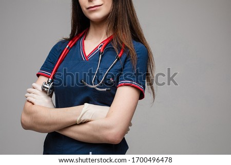Crop of a nurse with stethoscope in latex gloves.