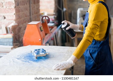 Crop Portrait Of Unrecognizable Young Woman Spray Painting Wood Piece While Working In Carpenters Workshop, Copy Space