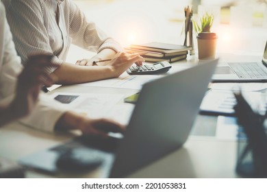 Crop Shot Of Business Woman Checks Her Work And Uses A Calculator To Calculate Her Annual Financial Statements. Turnover And Profit Balance Sheet Making Financial Records In Paper Audits.