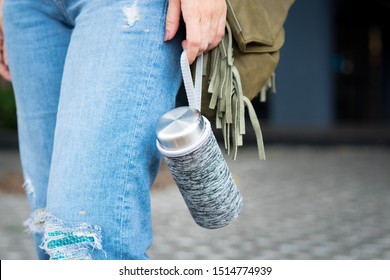 Crop Shot: Hand Of A Young Female Carry A Personal Reusable Water Bottle. Environmental Friendly, Eco Living, No One-time Use Plastic, No Straw, Urban Leisure, Zero Waste Awareness, Copy Space.