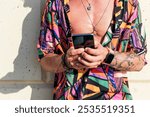 crop view of hipster man leaning using phone