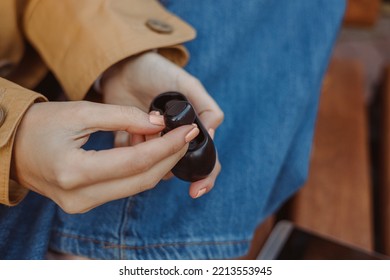 Crop Woman With Black True Wireless Earphones Case N Hands Sitting On Bench 