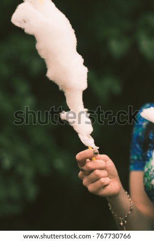 Similar – Image, Stock Photo Girl plucks off a piece of cotton candy