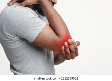 Cropped Of Black Man Rubbing His Injured Highlighted With Red Elbow, Side View, Copy Space