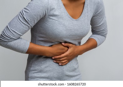 Cropped Of Black Woman Suffering From Gastritis, Touching Her Tummy