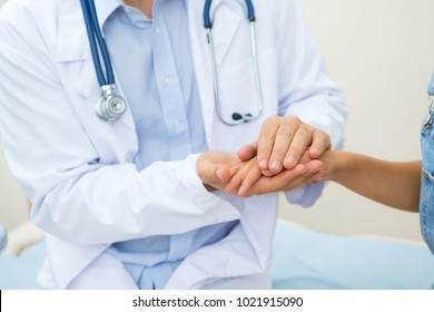 Cropped Close Up Of A Doctor In White Coat Comforting His Patient Holding Her Hand Reassuring Her And Supporting Profession Occupation Job Communication Interaction Trust Healthcare Medicine Worker