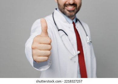 Cropped Close Up Fun Male Doctor Man Wears White Medical Gown Suit Work In Hospital Showing Thumb Up Like Gesture Isolated On Plain Grey Color Background Studio Portrait. Healthcare Medicine Concept