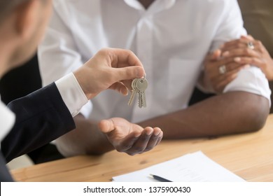 Cropped Close Up Image African Married Couple Owners Get Keys To House From Realtor Real Estate Agent, First Time New Home Buyers, Good Profit Deal, Mortgage Loan Approval, Moving Relocation Concept