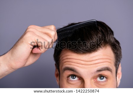 Cropped close up photo amazing he him his macho hands arms plastic hair styling brush take care hairdo barber shop stylist visit look up process experiment wear white t-shirt isolated grey background